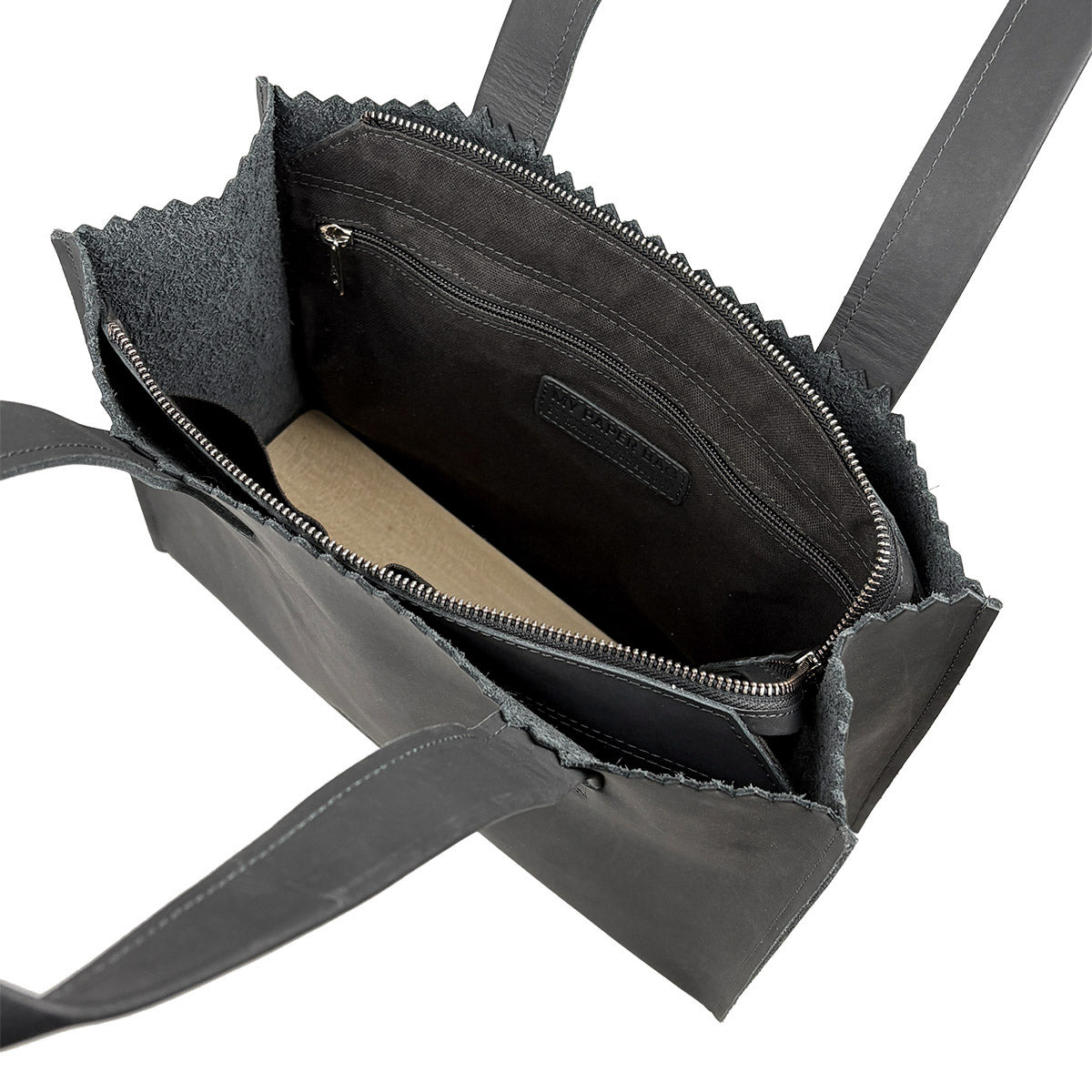 Black leather handbag with open front pocket on a white background