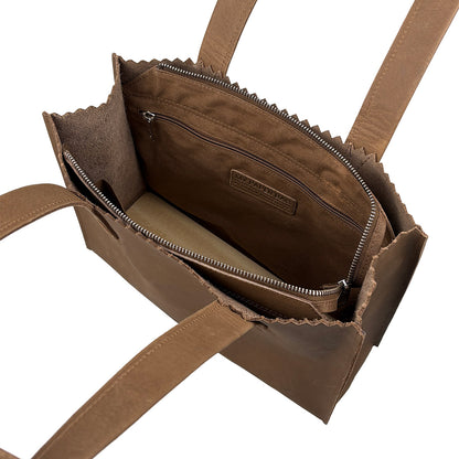 Brown leather handbag with visible brand logo on a white background